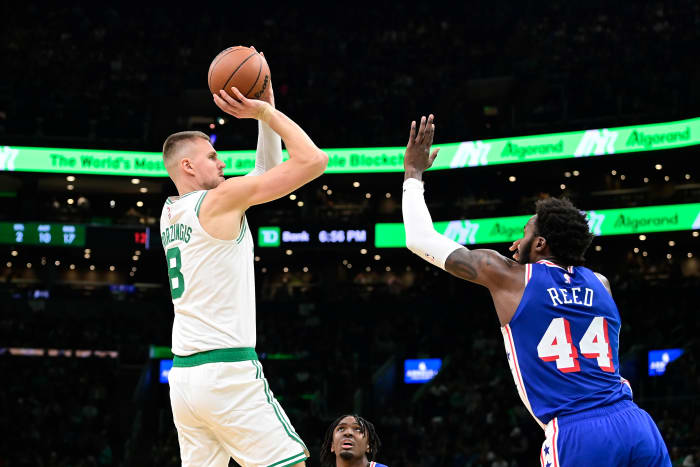 Boston Celtics center Kristaps Porzingis (8) shoots against Philadelphia 76ers forward Paul Reed (44) during the first half at TD Garden.